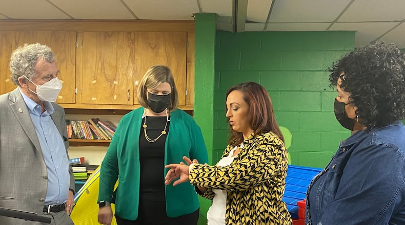 U.S. Senator Sherrod Brown, left, and Dayton mayor Nan Whaley, center, listen to Chloe Morgan, center, a mom of four kids, as Kim Jarvis, right, director of On Purpose Academy, looks on. Eileen McClory / staff