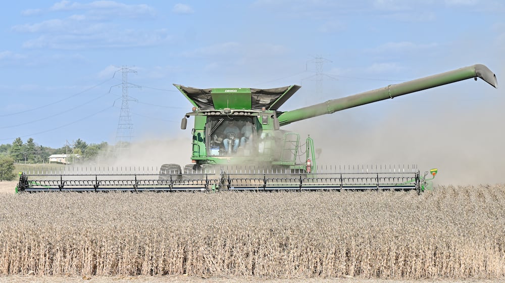 Farmers harvest soybeans in a field near Ohio 202 near Tipp City on Monday, Sept. 29, 2025. Tariffs on China and stalled trade negotiations are threatening the financial stability of soybean farmers nationwide. BRYANT BILLING/STAFF