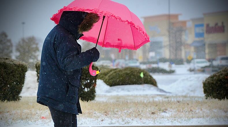 An umbrella is good for rain, sleet and snow. This woman was walking to the Target store in Beavercreek on February 3, 2022.