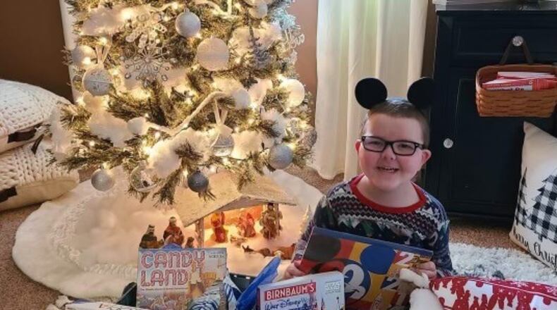 Zane, 6, received his wish box of board games and Disney apparel from the Dayton Chapter of A Special Wish Foundation.