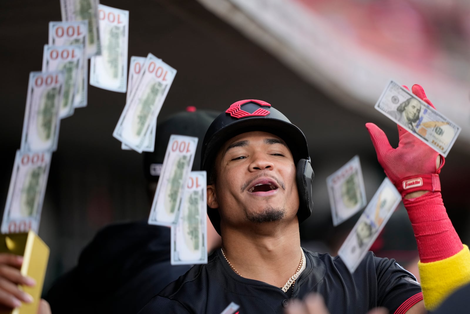 Cincinnati Reds' Noelvi Marte celebrates in the dugout after hitting a solo home run during the first inning of a baseball game against the St. Louis Cardinals Friday, Aug. 29, 2025, in Cincinnati. (AP Photo/Carolyn Kaster)
