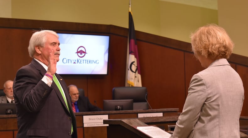 Maureen Patterson swears in Kettering Mayor Don Patterson for his final term in 2018. FILE PHOTO