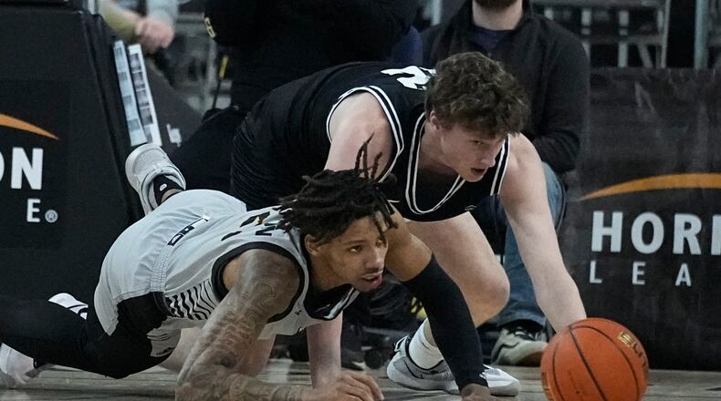 Northern Kentucky's Chris Brandon, left, and Wright State's AJ Braun scramble for the ball during the first half of an NCAA college basketball game for the Horizon League men's tournament championship Tuesday, March 8, 2022, in Indianapolis. (AP Photo/Darron Cummings)