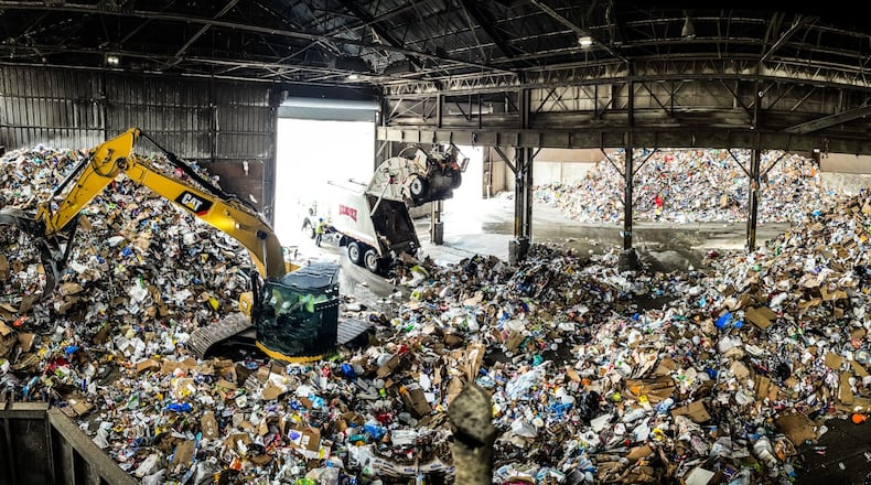 Rumpke dumps trash into its large recycling facility on Monument Ave. Glass and cardboard are separated and recycled. JIM NOELKER/STAFF