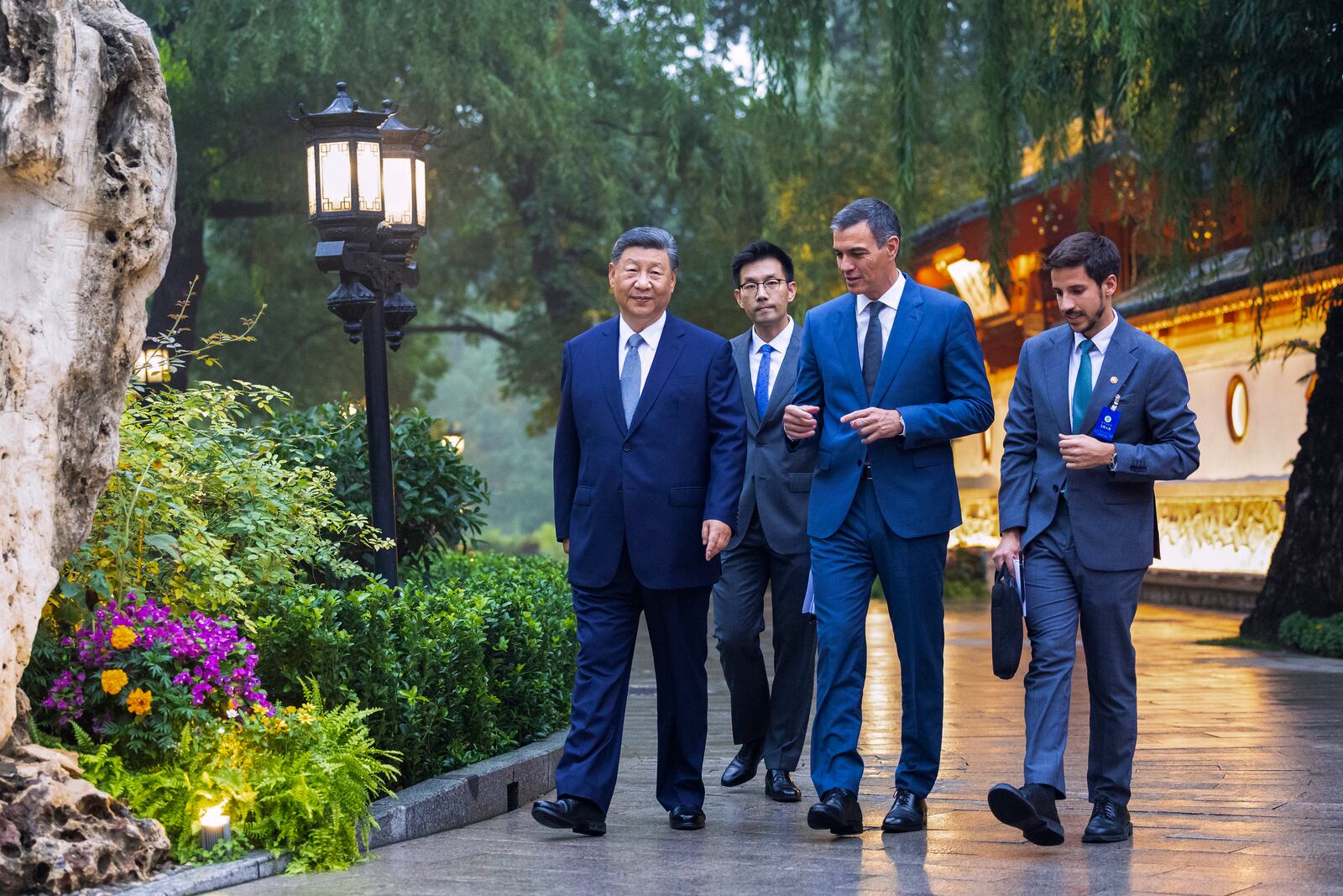 FILE - In this photo released by Xinhua News Agency, visiting Spainish Prime Minister Pedro Sanchez, second right, chats with Chinese President Xi Jinping, left, as they tour the Diaoyutai State Guesthouse in Beijing, Sept. 9, 2024. (Huang Jingwen/Xinhua via AP, File)