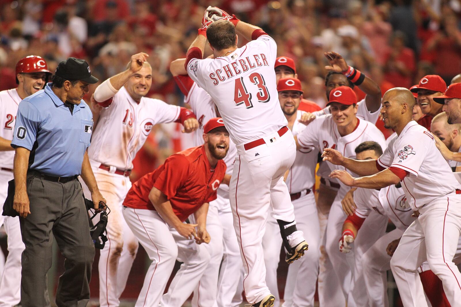 The Reds’ Scott Schebler celebrates at home plate after hitting a three-run walk-off home run against the Cardinals on Tuesday, Aug. 2, 2016, at Great American Ball Park in Cincinnati. David Jablonski/Staff