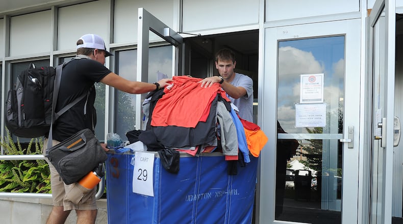 Hunter Turner, right, helps freshman Ryan West, move into Marycrest Residential Complex at the University of Dayton on move-in day, Wednesday Aug. 18, 2021. MARSHALL GORBY\STAFF