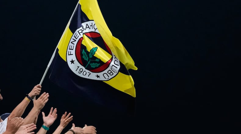 FILE - Fenerbahce fans celebrate the win of their team during the Europa League group B soccer match between AEK and Fenerbahce at AEK arena stadium in Larnaca, Cyprus, Oct. 13, 2022. (AP Photo/Petros Karadjias, File)