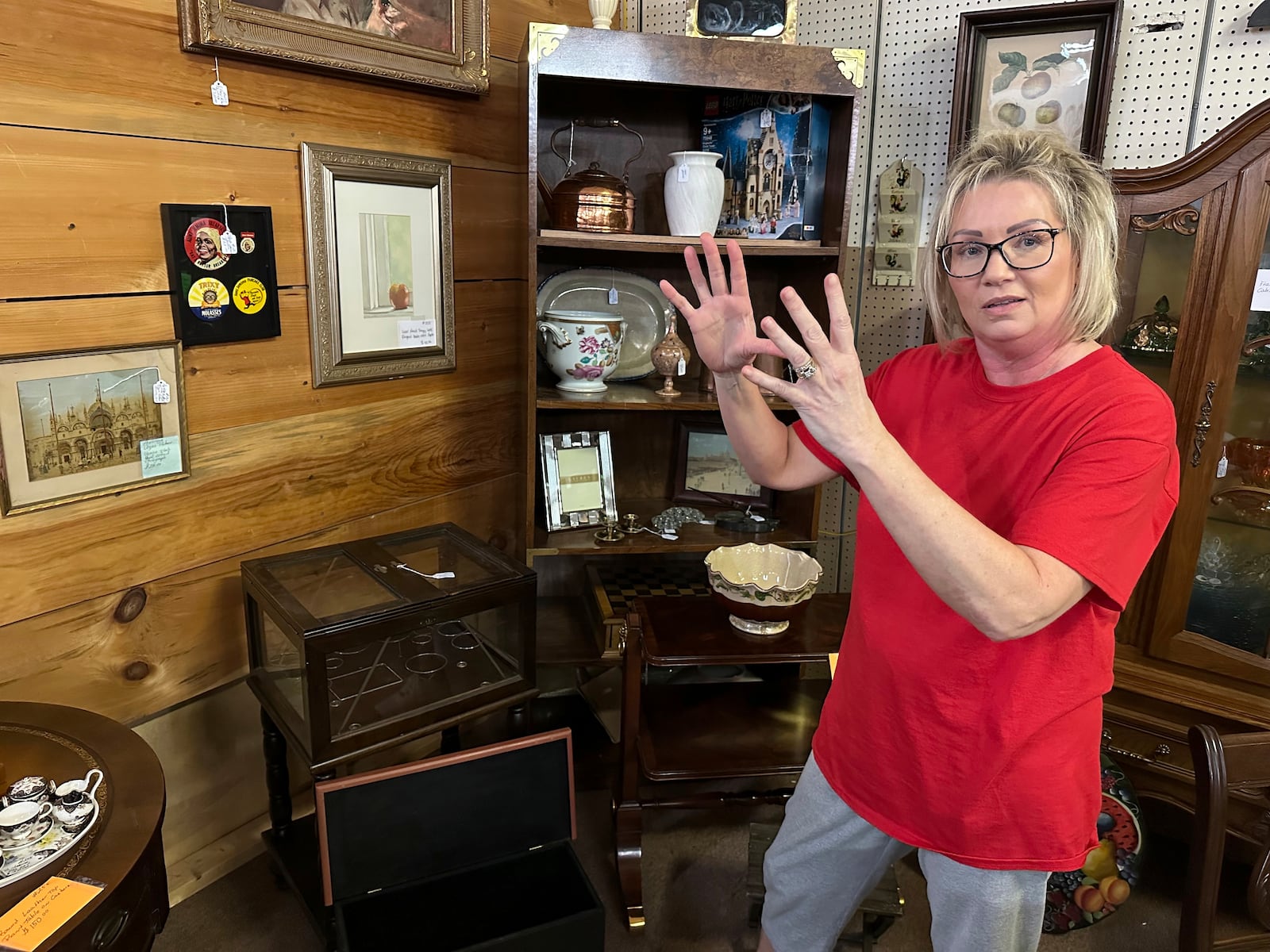 Michelle Hackworth discusses U.S. politics standing in her Paintsville, Ky., antiques store, Friday, May 16, 2025. (AP Photo/Bill Barrow)