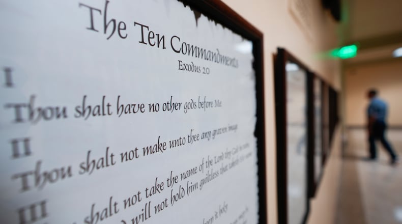 FILE - A copy of the Ten Commandments is posted along with other historical documents in a hallway of the Georgia Capitol, June 20, 2024, in Atlanta. (AP Photo/John Bazemore, File)