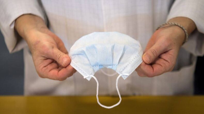 An Iowa woman is creating face masks and hanging them on a tree outside her home.