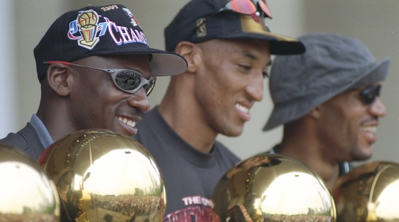16 Jun 1997: Guard Michael Jordan, forward Scottie Pippen and forward Dennis Rodman of the Chicago Bulls look at their trophies during the Chicago Bulls Victory Parade in Chicago, Illinois. The BUlls defeated the Utah Jazz in 6 games to win the 1998 NBA Championship Finals.
