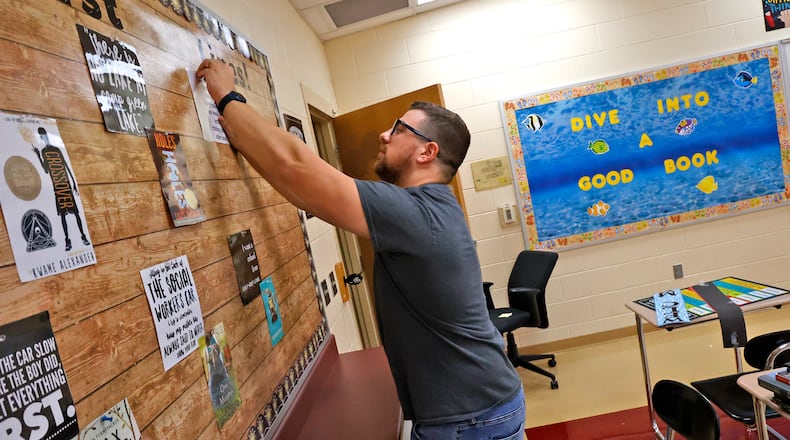 Paul Merkle, a sixth grade English/Language Arts teacher at Tecumseh Middle School, gets his classroom ready Friday, August 11, 2023. Classes start at Tecumseh on Wednesday, August 16. BILL LACKEY/STAFF