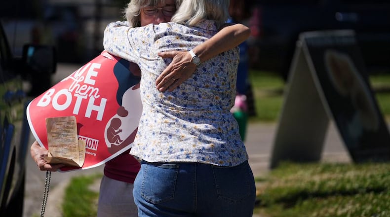 Mari Schoen  hugs a fellow supporter as they celebrate the overturning of Roe v Wade by the Supreme Court while standing outside of the Planned Parenthood Clinic in Columbus, Ohio, on Friday, June 24, 2022. The Supreme Court has ended constitutional protections for abortion that had been in place nearly 50 years in a decision by its conservative majority to overturn Roe v. Wade. Friday's outcome is expected to lead to abortion bans in roughly half the states.  (Courtney Hergesheimer/The Columbus Dispatch via AP)