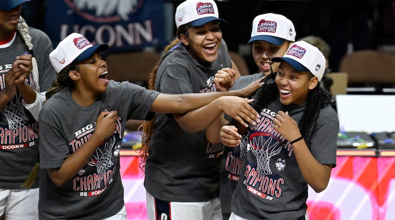 UConn's Kelis Fisher, left, Sarah Strong, second from left, and Azzi Fudd, second from right, acknowledge KK Arnold, right, as they celebrate winning an NCAA college basketball game against Villanova in the finals of the Big East tournament, Monday, March 9, 2026, in Uncasville, Conn. (AP Photo/Jessica Hill)