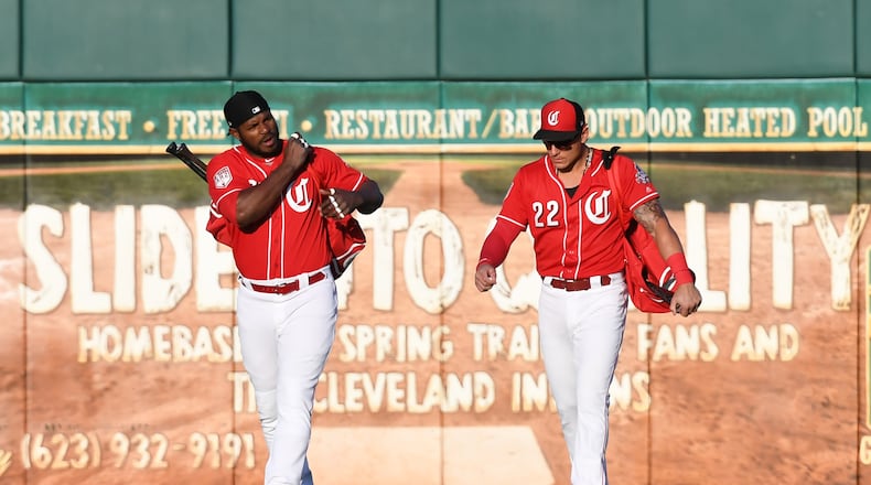 The Reds are full of new faces this year, like outfielder Yasiel Puig (left) and utility player Derek Dietrich. (Photo by Norm Hall/Getty Images)
