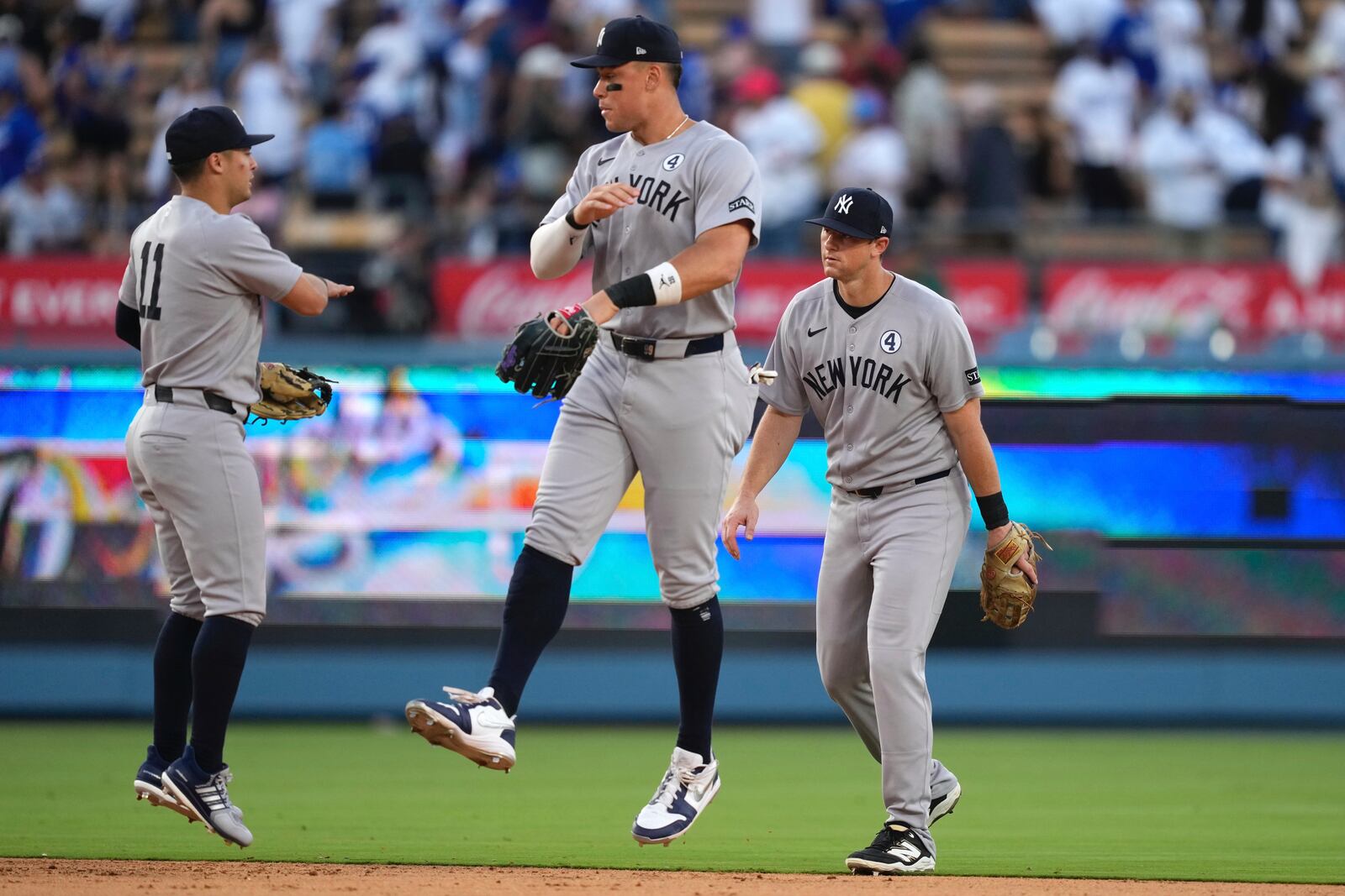 New York Yankees' Aaron Judge, center, celebrates with Anthony Volpe, left, and DJ LeMahieu after the Yankees defeated the Los Angeles Dodgers 7-3 in a baseball game Sunday, June 1, 2025, in Los Angeles. (AP Photo/Mark J. Terrill)