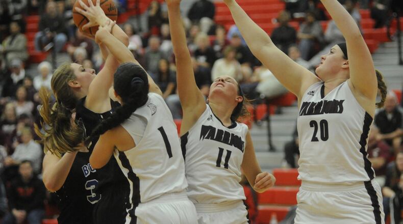 Springboro’s Lauren Thomas (with ball) draws Lebanon defenders Alexis Straw (1), Ashley West (11) and Cassidy Osborne. Springboro defeated Lebanon 54-31 in a girls high school basketball D-I sectional final at Troy on Friday, Feb. 24, 2017. MARC PENDLETON / STAFF