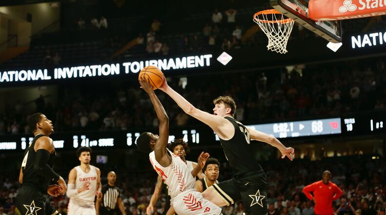 Dayton's Kobe Elvis has a shot blocked in the final seconds in overtime by Vanderbilt's Liam Robbins in the second round of the NIT on Sunday, March 20, 2022, at Memorial Gymnasium in Nashville, Tenn. David Jablonski/Staff