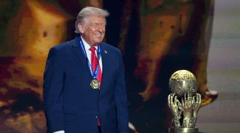 President Donald Trump smiles after being awarded the FIFA Peace Prize during the draw for the 2026 soccer World Cup at the Kennedy Center in Washington, Friday, Dec. 5, 2025. (AP Photo/Chris Carlson)
