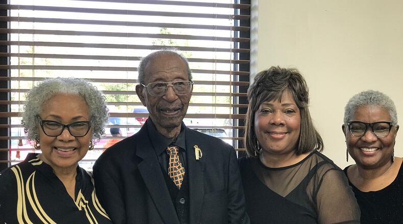 Marion Miller, a West Dayton World War II veteran who turned 100, with his three daughters (left to right) Pat McClure of Columbus; Lisa Tooson of Springfield and Shirley Hill of Macon, Ga. at his birthday party Saturday at St, Margaret’s Episcopal Church on Free Pike. Tom Archdeacon/CONTRIBUTED
