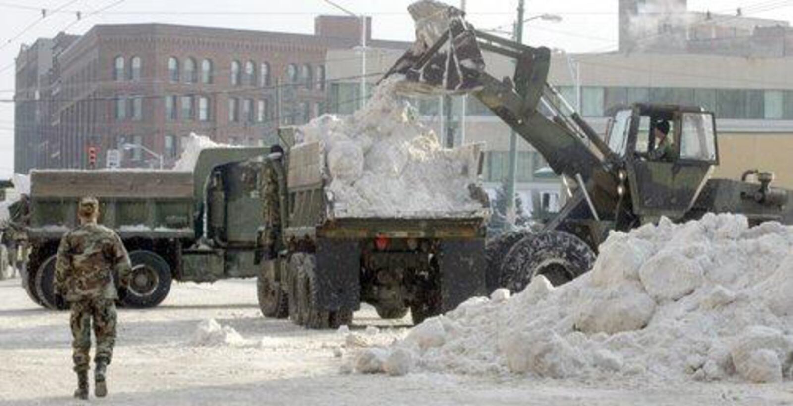 The Ohio National Guard removes snow from Dayton streets in the aftermath of the 2004 winter storm. DAYTON DAILY NEWS ARCHIVE
