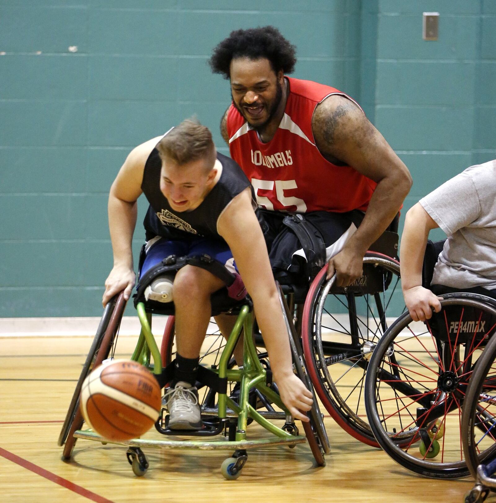 Alex Hilgeford of Riverside (foreground) and Justin “Nate” Knowles of Fairborn, go after a loose ball during practice for the Miami Valley Raptors, a nationally acclaimed wheelchair basketball team. LISA POWEL / STAFF
