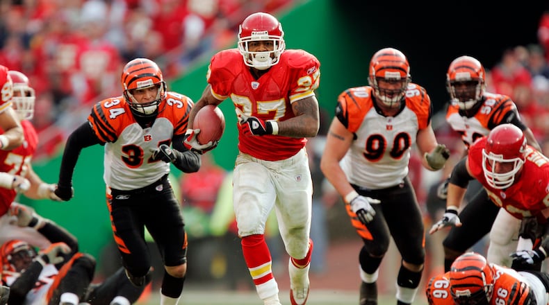 KANSAS CITY, MO - JANUARY 1: Running back Larry Johnson #27 of the Kansas City Chiefs breaks through a hole in the Cincinnati Bengals defense for his first touchdown in the second quarter on January 1, 2006 at Arrowhead Stadium in Kansas City, Missouri. (Photo by Brian Bahr/Getty Images)