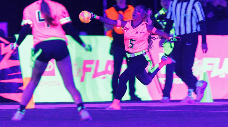 Team Pink's Gigi Torres (5) of Manteca High School, scores a touchdown against Team Green during the Toyota Glow-Up Classic flag football game in San Francisco on Wednesday, Feb. 4, 2026. (Santiago Mejia/San Francisco Chronicle via AP)
