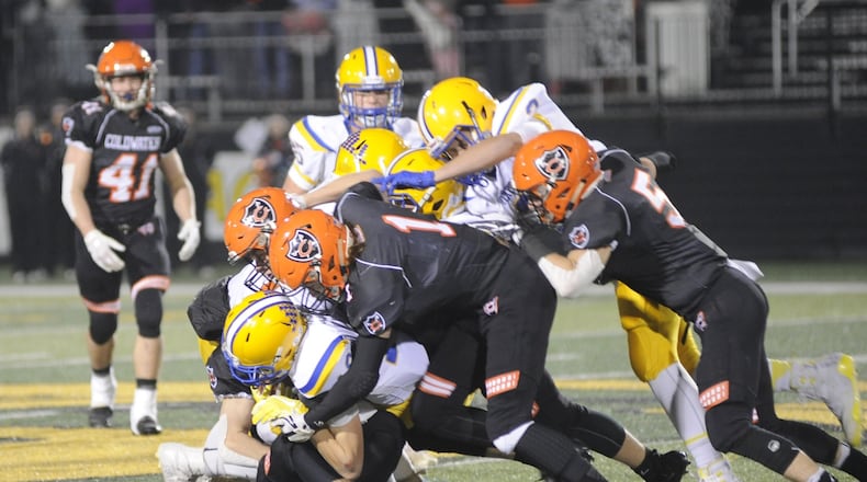 Coldwater defenders Ross Weigel (1) and Alex May (5) take down Matt Rethman. Marion Local defeated Coldwater 40-19 in a D-VI, Region 24 final at Sidney on Friday, Nov. 16, 2018. MARC PENDLETON / STAFF
