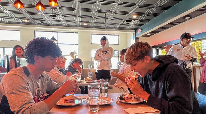 Student athletes from Centerville High School and The Miami Valley School battled head-to-head on Oct. 22 to see who could eat All The Best Delicatessen’s secret menu item, “The Stupid-Big Sandwich,” in the fastest time. CONTRIBUTED PHOTO