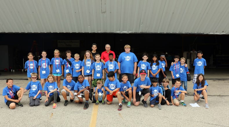 Frank Beafore (center in the red shirt). executive director of the SelectTech GeoSpatial presence at Springfield-Beckley Municipal Airport, with a few of his friends -- a group of Air Camp students. Contributed