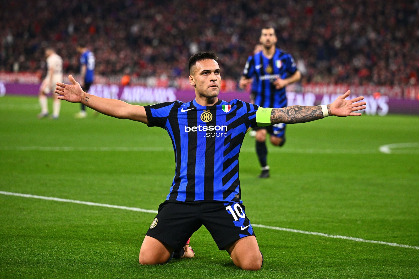 Inter Milan's Lautaro Martinez celebrates after scoring the opening goal during the Champions League quarterfinals first leg soccer match between FC Bayern Munich and Inter Milan, at the Allianz Arena in Munich, Germany, Tuesday, April 8, 2025. (Tom Weller/dpa via AP)