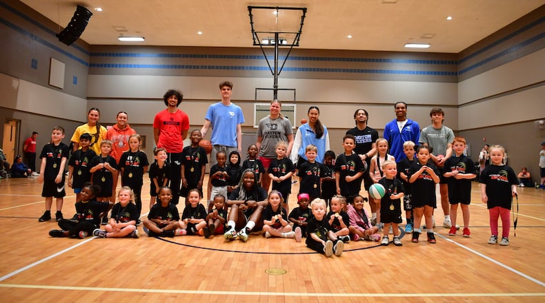Members of the Bitty Ballers basketball camp pose with instructors, including Dayton basketball players, in 2025. Contributed photo