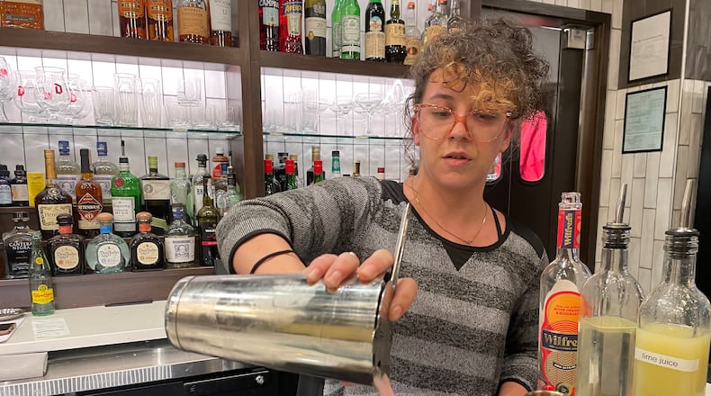 Tori Adams makes a non-alcoholic beverage at Gather by Ghostlight. The Wilfred Sour features Wilfred non-alcoholic aperitif, lime juice, simple syrup and egg whites. NATALIE JONES/STAFF