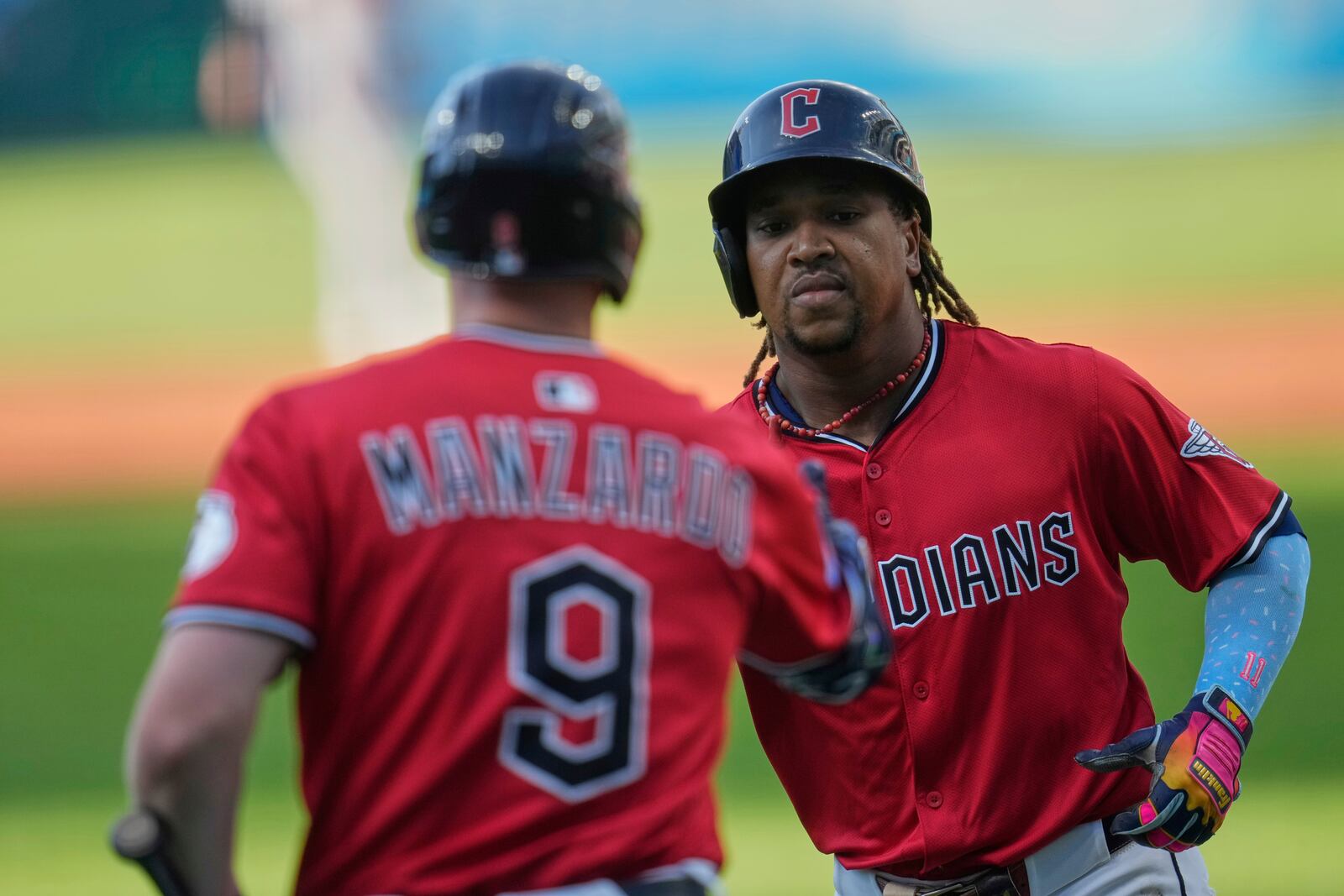 Cleveland Guardians' Jose Ramirez, right, is congratulated by Kyle Manzardo (9) after his home run in the first inning of a baseball game against the Baltimore Orioles in Cleveland, Tuesday, July 22, 2025. (AP Photo/Sue Ogrocki)