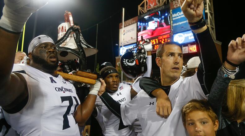 OXFORD, OH - SEPTEMBER 16: Head coach Luke Fickell and Korey Cunningham #71 of the Cincinnati Bearcats celebrate with the Victory Bell following their 21-17 win over the Miami Ohio Redhawks at Yager Stadium on September 16, 2017 in Oxford, Ohio. (Photo by Michael Reaves/Getty Images)