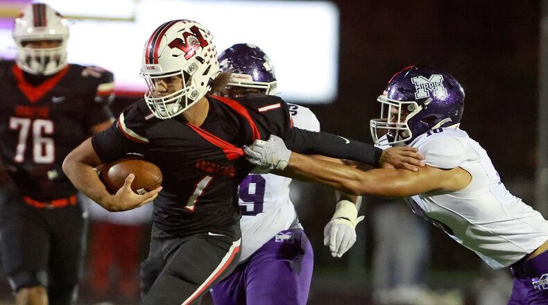 Middletown's Tray Tillis tries to tackle Wayne quarterback Tyrell Lewis as he carries the ball during Friday's game. BILL LACKEY/STAFF