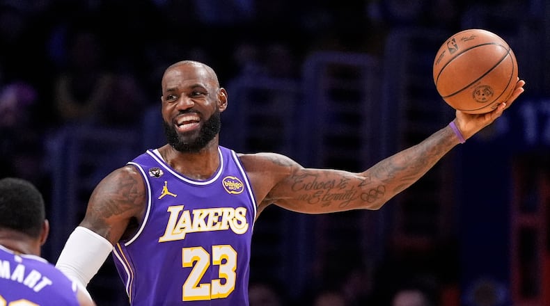 Los Angeles Lakers forward LeBron James smiles as he tries to pass during the first half of an NBA basketball game against the Dallas Mavericks, Thursday, Feb. 12, 2026, in Los Angeles. (AP Photo/Mark J. Terrill)