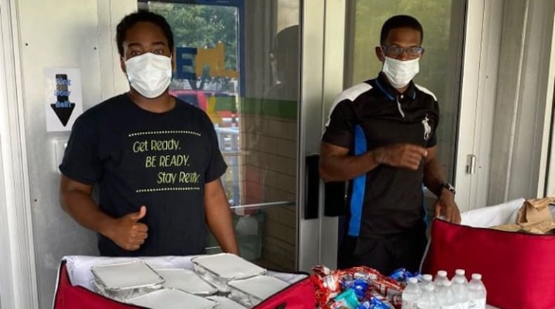 Volunteers prepare the day's free, no-contact meals to be given out at the Boys and Girls Club of Dayton. CONTRIBUTED