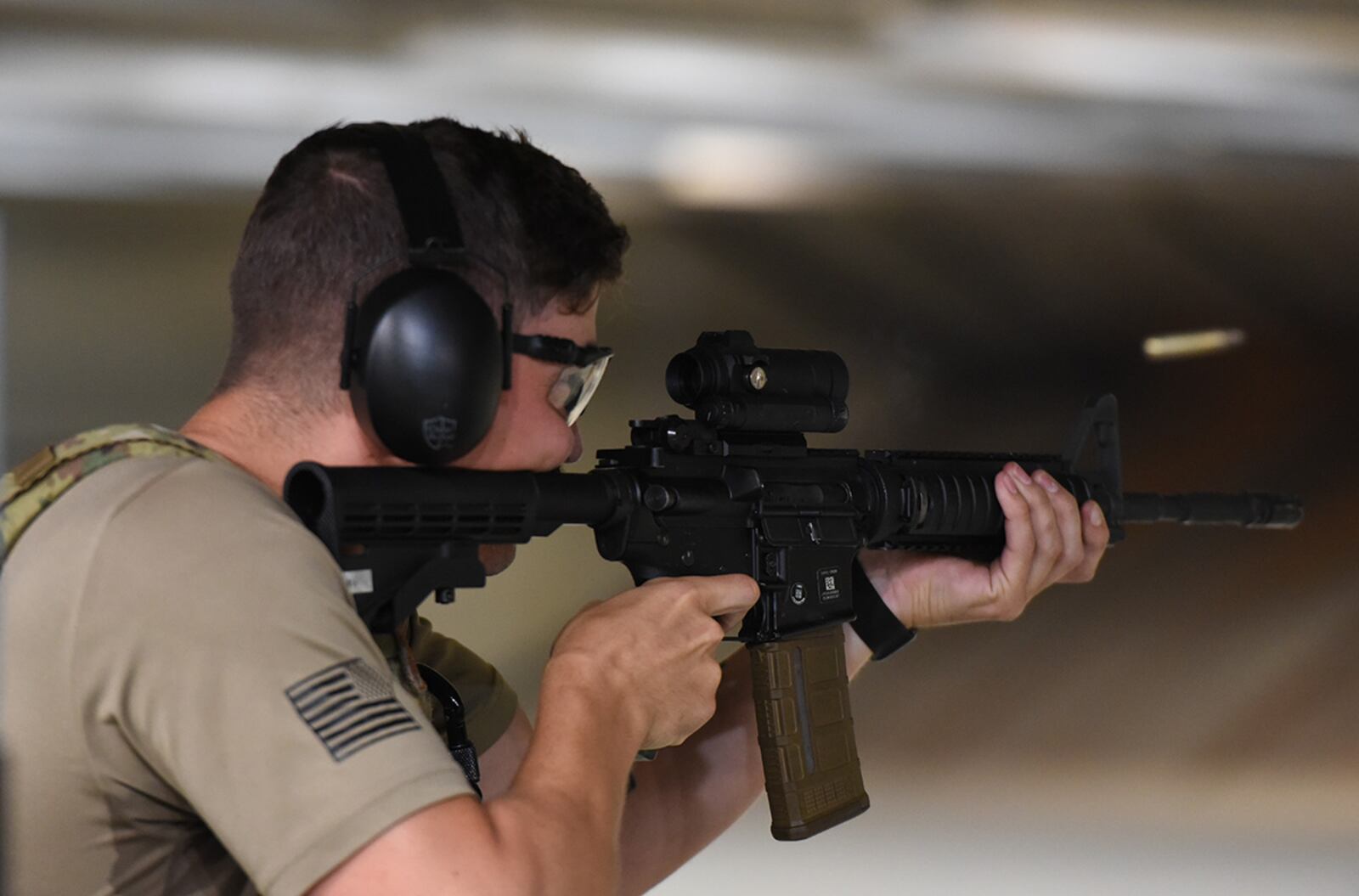Senior Airman Paiden Carlisle, 88th Security Forces Squadron vehicle control official, fires an M4 carbine July 22 at Wright-Patterson Air Force Base’s indoor firing range. U.S. AIR FORCE PHOTO/MATTHEW CLOUSE