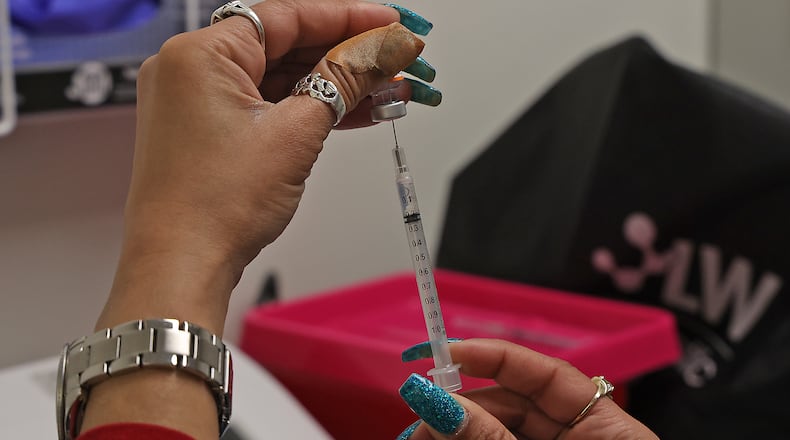 Samples of increased viral gene copies of COVID-19 have been taken from a Springfield wastewater plant. Here, Senika Channels previously got a a patient's COVID vaccine ready at the Clark County Combined Health District clinic. BILL LACKEY/STAFF