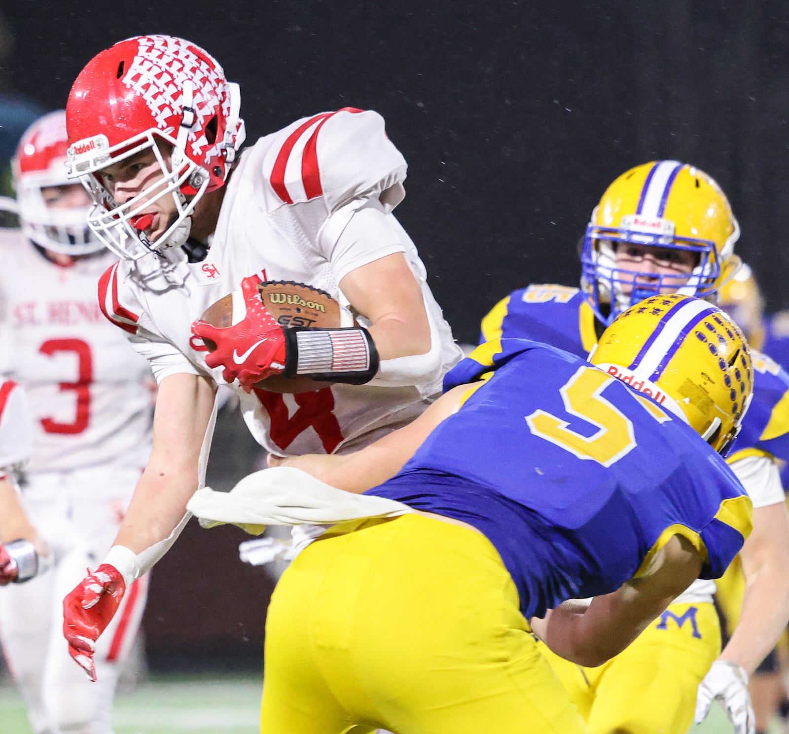 St. Henry senior receiver Jack Huelsman fights for extra yardage as Marion Local's Brayden Mescher during the Division VII, Region 28 championship on Friday, Nov. 21 at Mercy Health/Wapak VFW Field in Wapakoneta. BRYANT BILLING/STAFF
