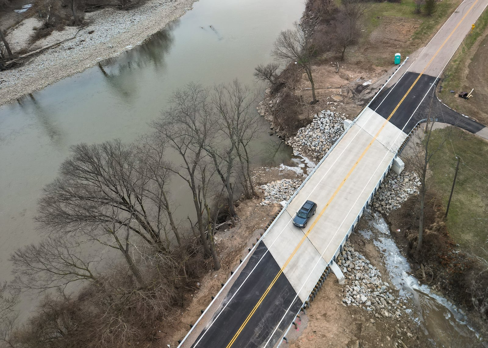 A car travels over the Franklin-Trenton Road bridge Dec. 30, 2025, in Franklin Twp., just days after it opened. A portion of the old bridge collapsed over Dry Run on Feb. 27, 2025, roughly 10 months earlier. NICK GRAHAM/STAFF