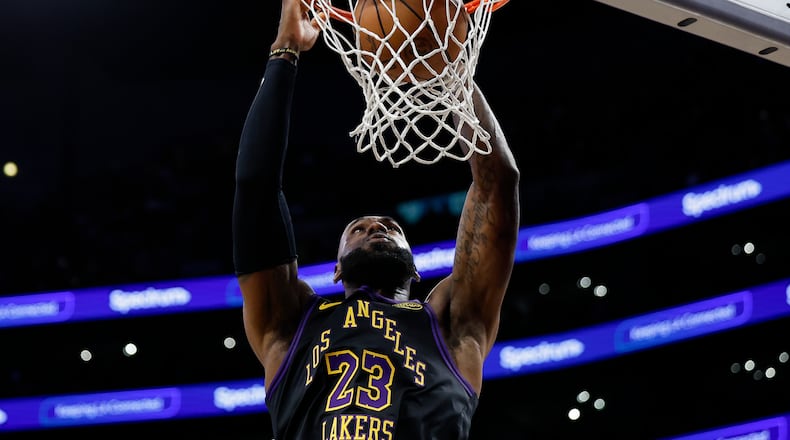 Los Angeles Lakers forward LeBron James (23) dunks the ball during the second half of an NBA basketball game against the Orlando Magic, Tuesday, Feb. 24, 2026, in Los Angeles. (AP Photo/Caroline Brehman)
