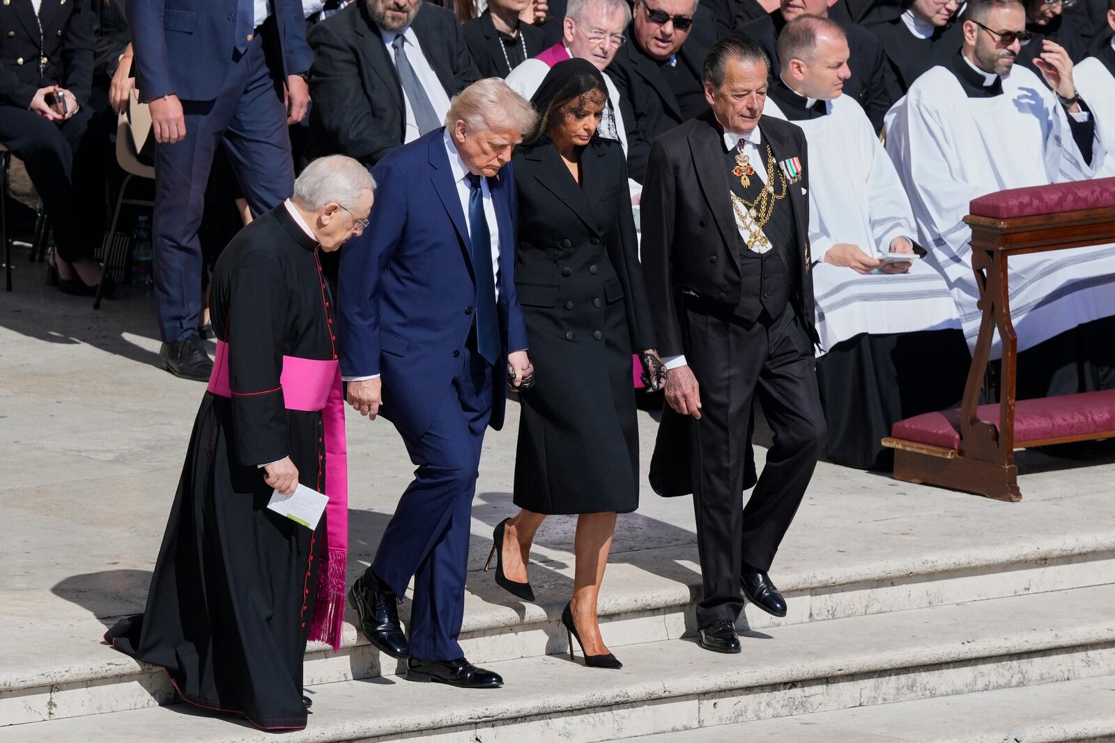 President Donald Trump and first lady Melania Trump, center, arrive for the funeral of Pope Francis in St. Peter's Square at the Vatican, Saturday, April 26, 2025. (AP Photo/Gregorio Borgia)