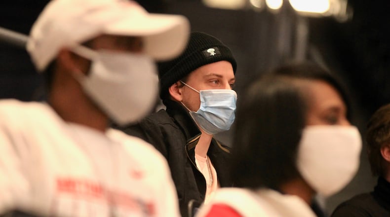 Bengals quarterback Joe Burrow watches a game between Dayton and George Mason on Friday, Feb. 5, 2021, at UD Arena.