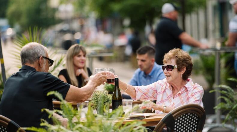 Couples enjoy outdoor dining during First Friday in downtown Dayton. CONTRIBUTED