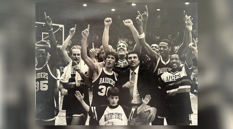 Nine-year-old Matt Brown, standing in front of head coach Ralph Underhill, celebrates with the 1983 Wright State Raiders team on their run to the NCAA Division II national championship. This photo is thought to be after the Elite Eight victory over Bloomsburg State. CONTRIBUTED PHOTO