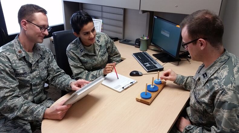 Capt. Tim Pagano (right), a clinical psychology resident at the Wright-Patterson Medical Center Neuropsychology Clinic, performs an assessment of mental flexibility and decision making. Individuals with Alzheimer’s disease may show a decline in executive functioning skills over time. Overseeing the assessment are Maj. (Dr.) Earl Banning, director of Neuropsychology at the medical center, and Capt. Safa Rashid, also a clinical psychology resident. (U.S. Air Force photo/Bryan Ripple)